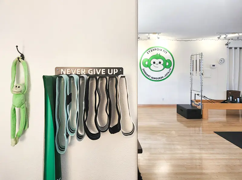 Never Give Up motivational sign and training equipment inside the private Fit Monkeys personal training studio in Carlsbad.
